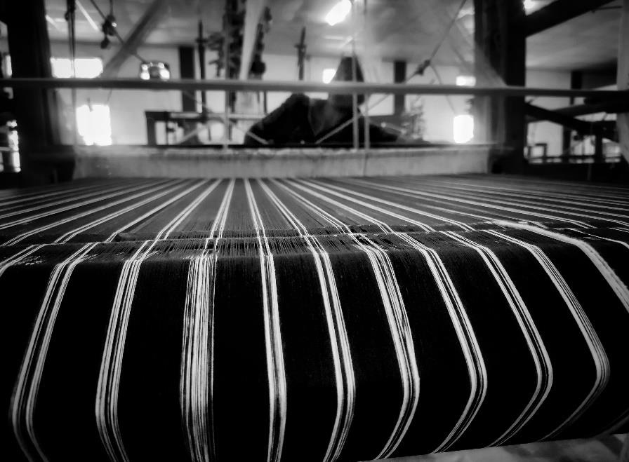 Women artisans weaving handloom fabric in Dimoria Block, Assam